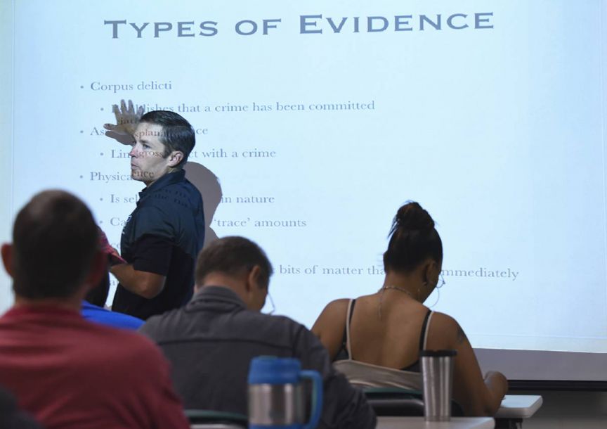 Instructor teaching criminal justice concepts to students in a classroom setting.