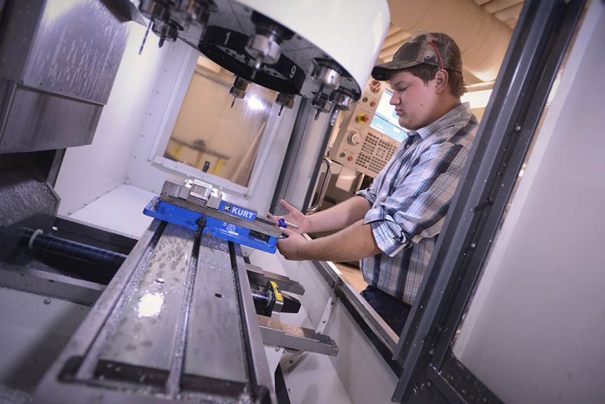 CNC machining in progress for mechanical design and fabrication students at Pensacola State College.