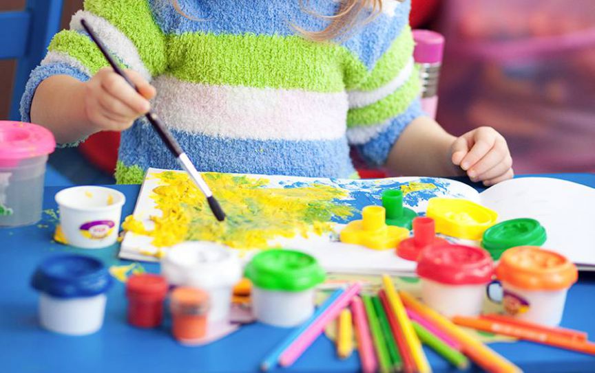 Child painting activity for early childhood education program.