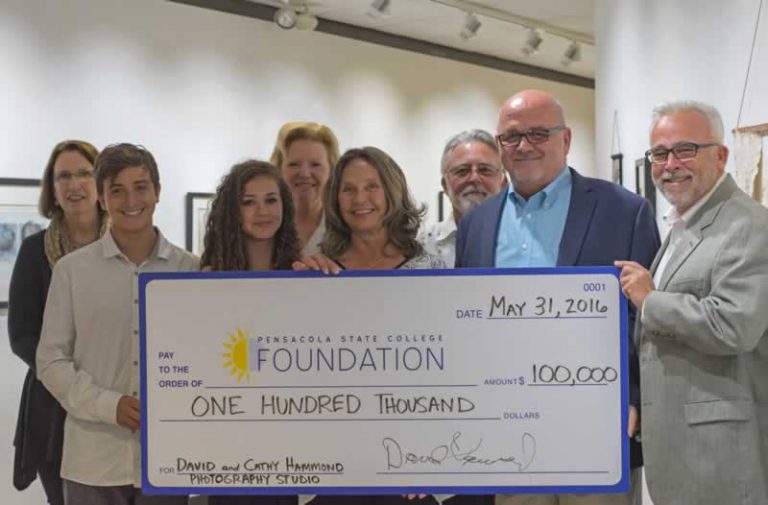 Large check presentation for Pensacola State College's visual arts program funding support.