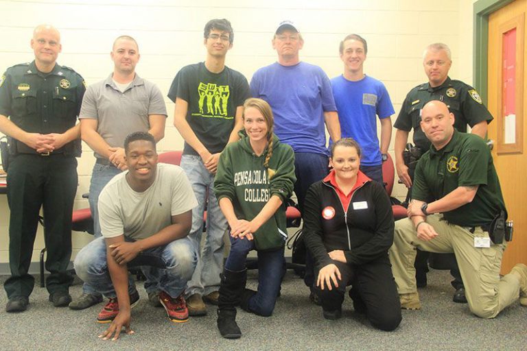 Pensacola State students practicing real-life law enforcement scenarios with officers.