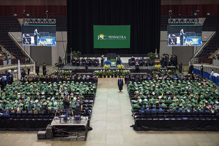 Graduates in caps and gowns at Pensacola State College graduation event.