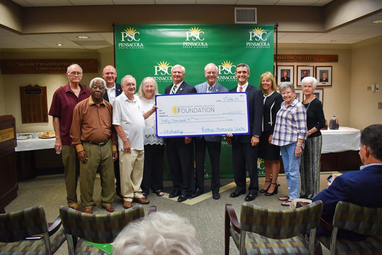 Retirees present $30,000 donation to Pensacola State College for community support.