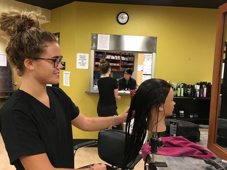 High school students preparing for college with professional attire at Pensacola State's Suit-Up eve.
