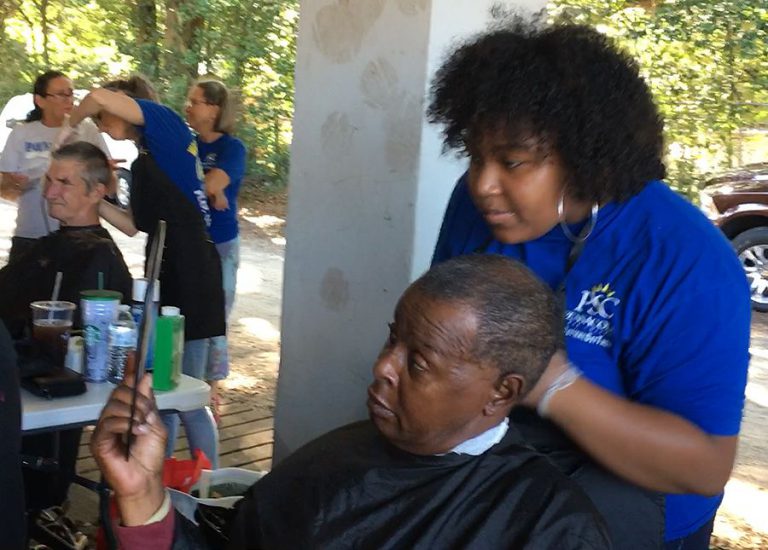 Students from Pensacola State College offering complimentary grooming services to veterans.