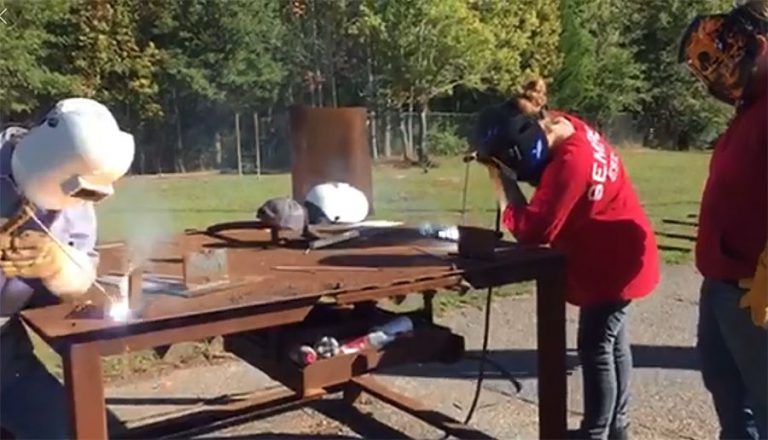 Students practicing welding outdoors at Pensacola State College Century Center.
