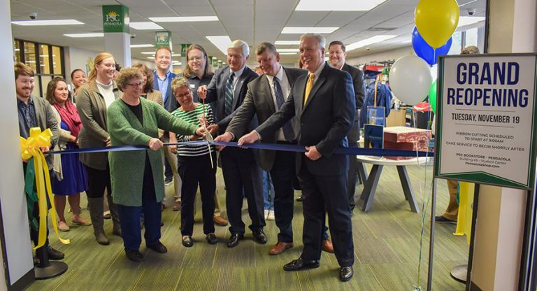 Brightly lit bookstore interior featuring staff and guests celebrating grand reopening event.