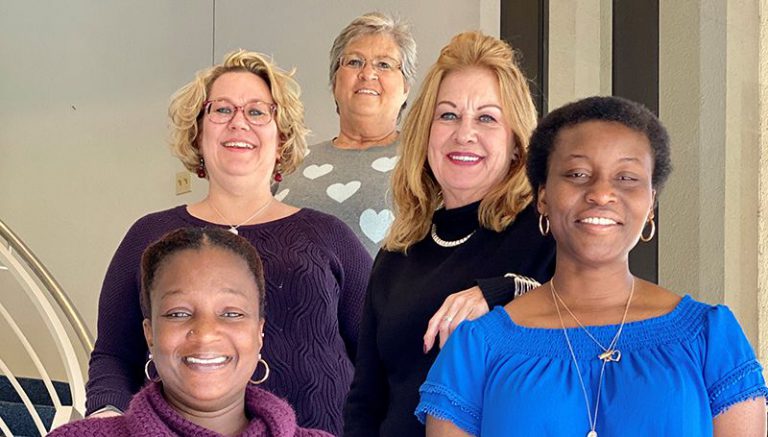 Diverse group of women leaders celebrating AFC chapter recognition at Pensacola State College.