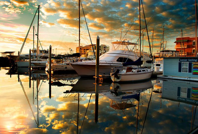 Marina sunset with boats, reflecting water, and vibrant sky at Pensacola State College.