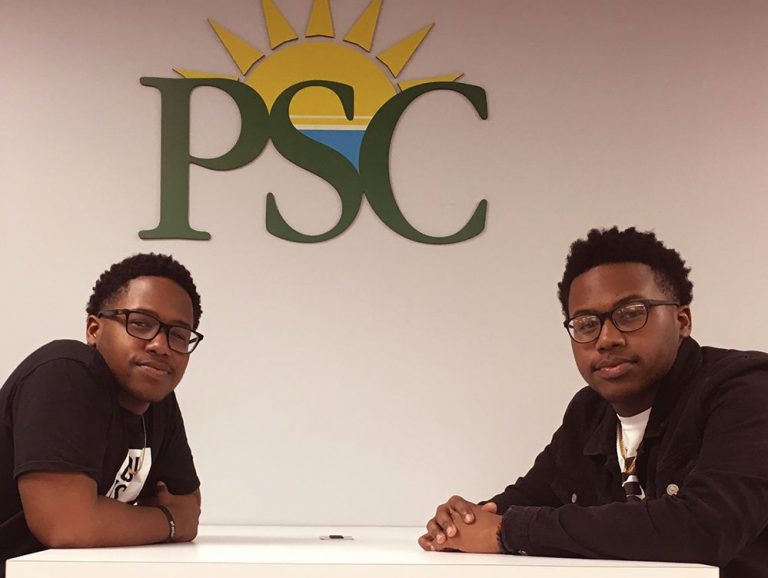 Twin brothers at Pensacola State College campus, showcasing higher education opportunities for stude.