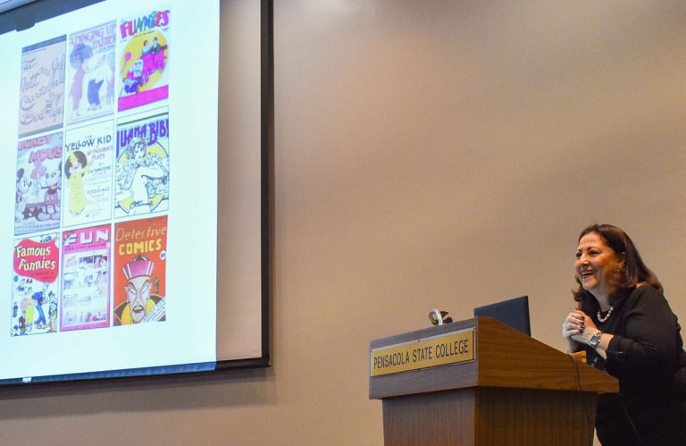 Female speaker discusses female superheroes and comics at Pensacola State College event.