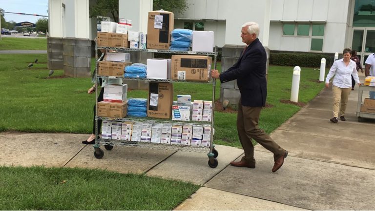 Donating medical protective gear to healthcare facilities at Pensacola State College.