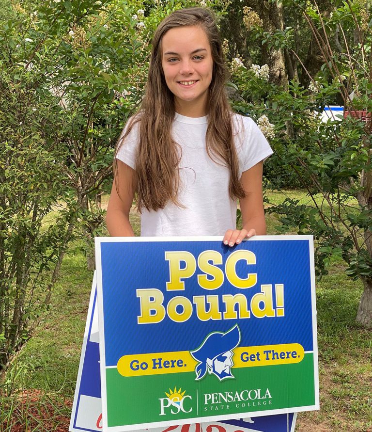 Young woman holding a Pensacola State College sign promoting college athletics and student-athlete s.