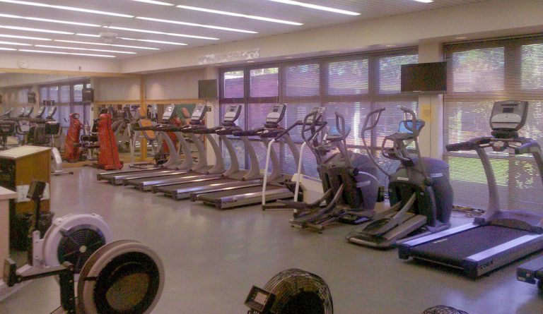 Modern gym equipment at Pensacola State College fitness centers with Covid-19 safety measures.