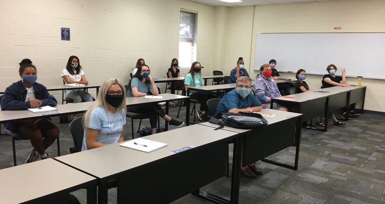 Classroom scene showing students wearing masks during a lecture at Pensacola State College.
