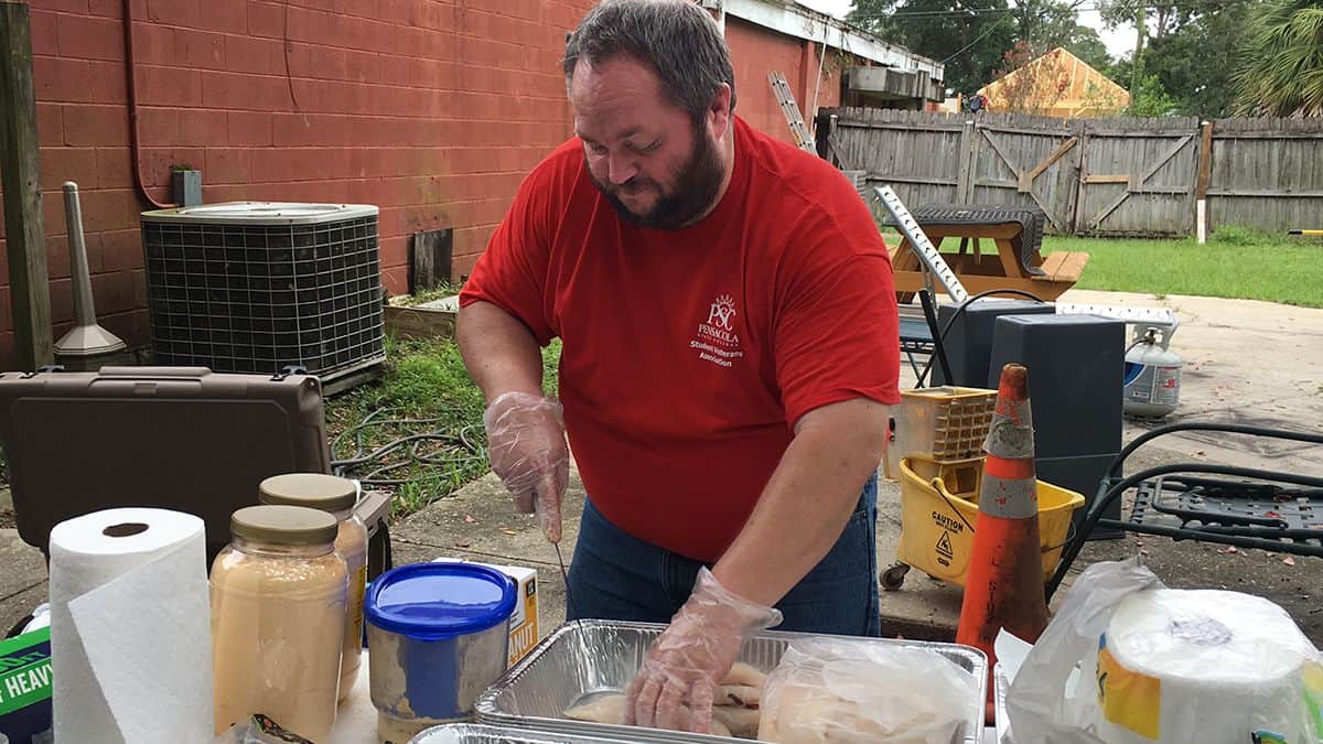 Student Veterans Association member volunteering at community service event Student Veterans Association member participating in community service event honoring 9-11 tragedy.
