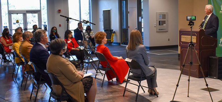 College event with audience listening to speaker on stage at Pensacola State College.