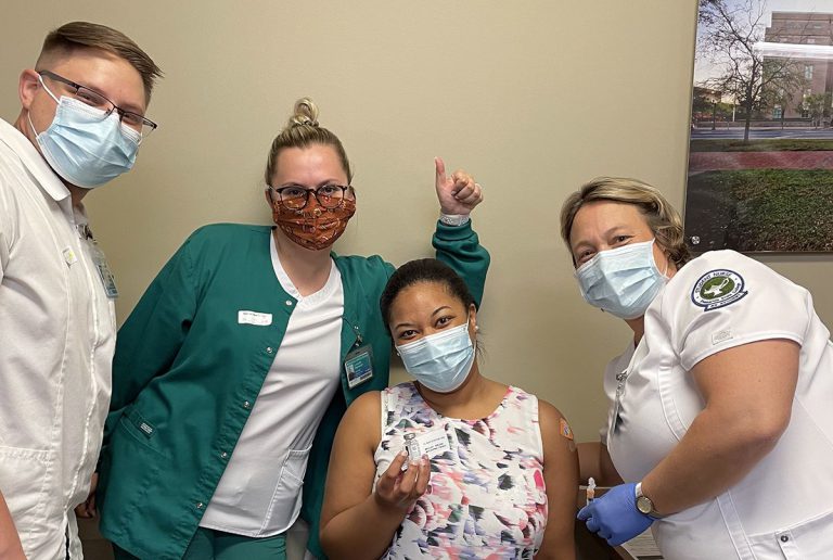 Nursing students at Pensacola State College participate in COVID-19 vaccination campaign, supporting.