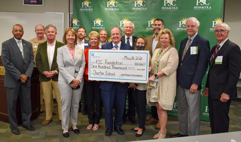 Technology Innovation Center Funding Announcement Group of officials holding a large check for $100,000 from Gulf Power Foundation for PSC tech center.