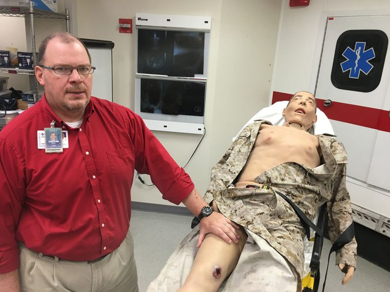 Pensacola State College EMS training manikin for realistic emergency response practice Realistic EMS training manikin at Pensacola State College designed to simulate injury and pain for s.