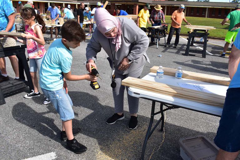 Massive volunteer turnout at PSC for Sleep in Heavenly Peace bed build Volunteer building beds at Pensacola State College for Sleep in Heavenly Peace.