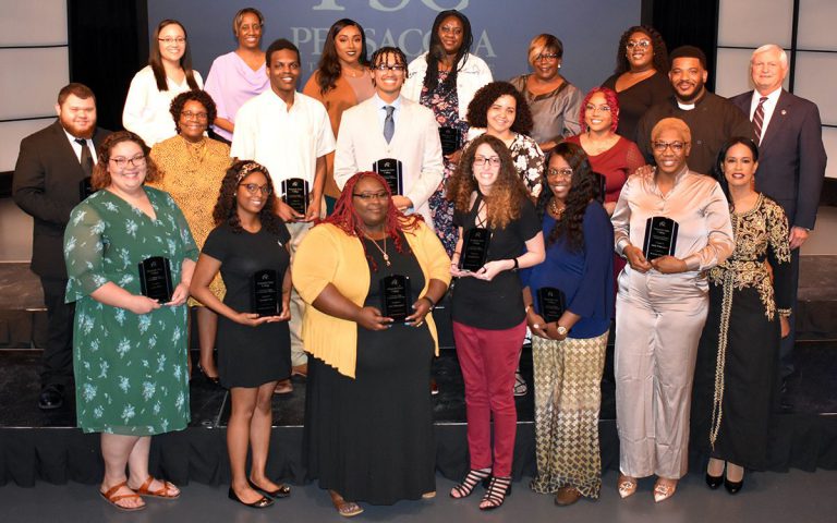 African American scholarship recipients celebrate at Pensacola State College event. Diverse group of students and supporters at PSC African American Memorial Endowment Scholarship cere.