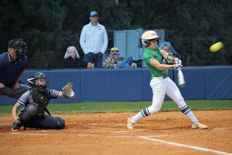 High school softball player swinging at pitch during game High school softball player batting during game at Pensacola State College.
