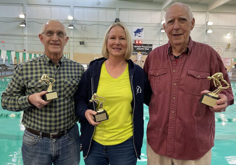 Gulf Coast Pirate Swimmers Team wins at Auburn Masters meet An image of three smiling team members holding trophies after winning at the Auburn Masters SCY Invi.