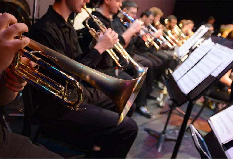 Brass instrument performance by Pensacola State College students in a college band.