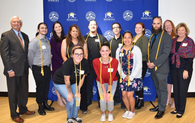 Diverse group of students and faculty celebrating academic excellence and leadership.