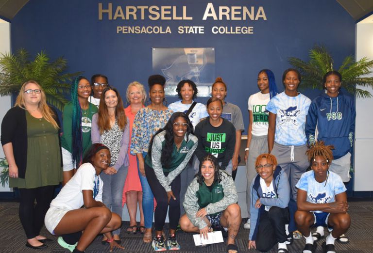 Women’s basketball team at Pensacola State College engaged in domestic violence awareness discussion.