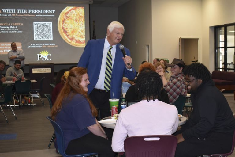 President engaging students during Pizza with the President event at Pensacola State College.