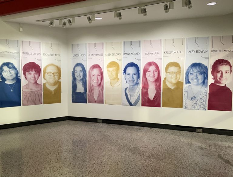 PSC Graphic Design Senior Exhibition showcases student talent and program impact. Portrait display of students' artwork at the senior exhibition.