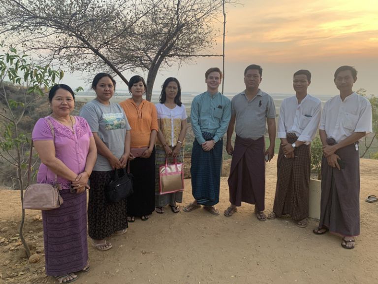 Community members and volunteers at sunset in Myanmar, highlighting cultural exchange and international service. Community members and volunteers at sunset in Myanmar, highlighting cultural exchange and internatio.