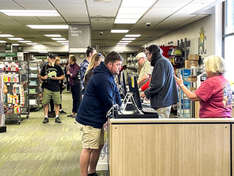 Spring semester student registration at college bookstore Student registering for classes during spring semester at college bookstore.