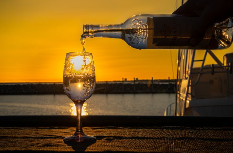 Elegant glass with sparkling drink during sunset at Pensacola State College event.