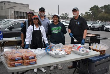 Community volunteers preparing food for Homecoming event at Pensacola State College.