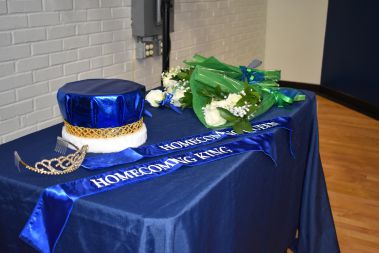 Elegant homecoming crown and floral arrangement for college event.