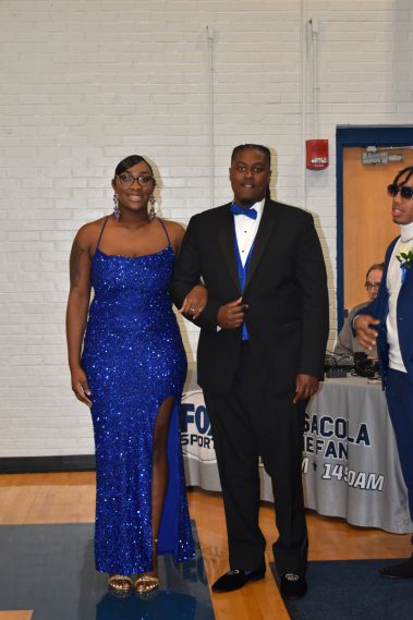 Elegant students dressed in formal attire for Homecoming event.