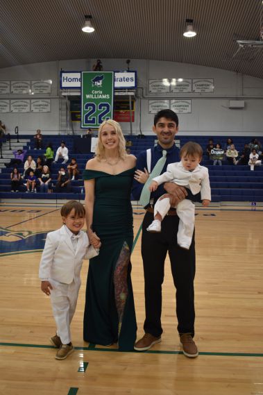Family enjoying Homecoming celebration at Pensacola State College basketball game.