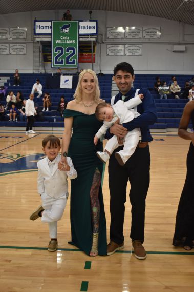 Family enjoying the Homecoming event at Pensacola State College basketball game.