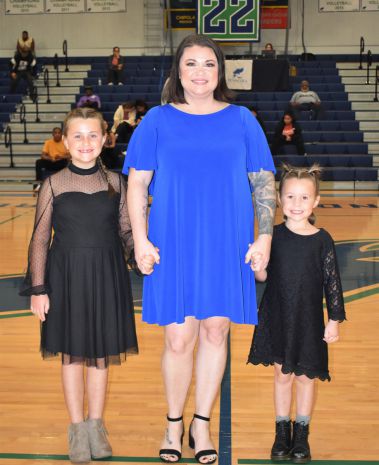 Beautiful woman with two young girls at college homecoming event.