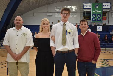 Smiling students and faculty celebrating Homecoming event at Pensacola State College gymnasium.
