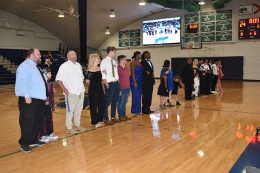 Diverse group of students and staff standing in line during a college homecoming event at Pensacola.