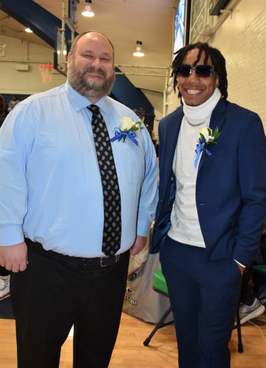 Smiling students at Pensacola State College Homecoming event in formal attire.