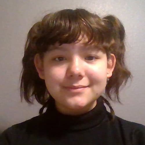 Esther Ramirez at Pensacola State College Portrait of Esther Ramirez, a student at Pensacola State College, smiling confidently in a casual se.