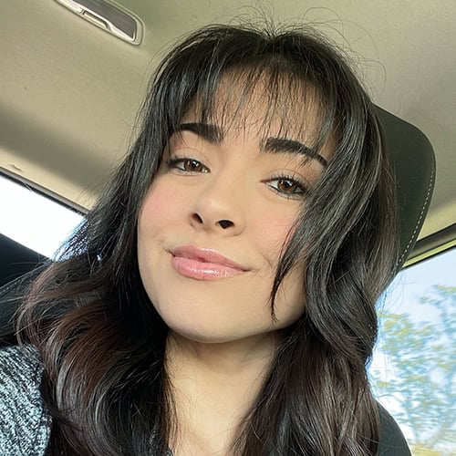 Student portrait of Maryna Seliz Sanchez, smiling with long dark hair, in a vehicle, showcasing diversity and student success at Pensacola State College.