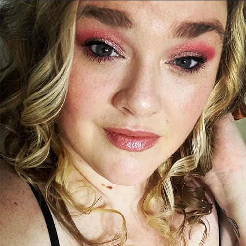 Megan Crain at Pensacola State College graduation ceremony Close-up of Megan Crain with makeup, smiling, at Pensacola State College event.