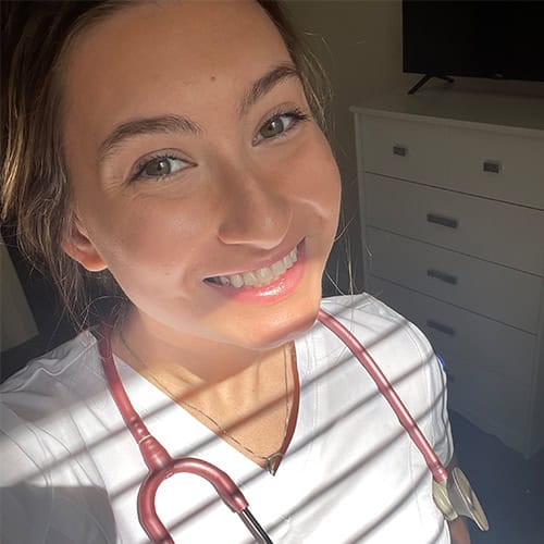 Nursing student smiling with stethoscope at Pensacola State College Nursing student with stethoscope, smiling, in a clinical setting at Pensacola State College.
