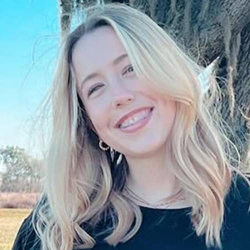 Sara McVoy smiling outdoors at Pensacola State College campus, showcasing higher education and student success. Sara McVoy smiling outdoors at Pensacola State College campus, showcasing higher education and stude.